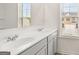 Modern bathroom with gray vanity and a window at 315 Silver Moon Drive, Loganville, GA 30052