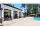 Covered patio area with tables and chairs near the pool at 315 Silver Moon Drive, Loganville, GA 30052