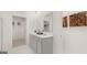 Double vanity bathroom with a linen closet and grey cabinets at 596 Silver Moon Drive, Loganville, GA 30052