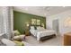 Bright bedroom with green accent wall and en-suite bathroom access at 596 Silver Moon Drive, Loganville, GA 30052