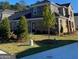 Two-story home with stone and brick exterior, showcasing a well-manicured lawn at 596 Silver Moon Drive, Loganville, GA 30052