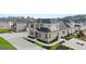 Luxury townhome with gray brick and stone accents, and a landscaped lawn at 596 Silver Moon Drive, Loganville, GA 30052