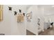 Light and airy hallway with wood floors and unique wall decor at 596 Silver Moon Drive, Loganville, GA 30052