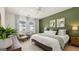 Spacious main bedroom with green accent wall and ample natural light at 596 Silver Moon Drive, Loganville, GA 30052