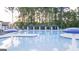 Resort-style pool with spacious deck and shade structures at 596 Silver Moon Drive, Loganville, GA 30052