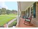 Spacious front porch with rocking chairs and view of yard at 100 Aspen Way, Fayetteville, GA 30214