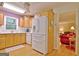 Bright kitchen with oak cabinets, white appliances, and a view to living room at 100 Aspen Way, Fayetteville, GA 30214