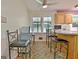 Bright kitchen with island, wood cabinets, and view to backyard at 100 Aspen Way, Fayetteville, GA 30214