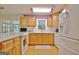 Spacious kitchen with oak cabinets, white appliances and ample counter space at 100 Aspen Way, Fayetteville, GA 30214
