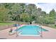 Sparkling blue pool surrounded by lush greenery at 100 Aspen Way, Fayetteville, GA 30214