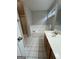 Bathroom with a bathtub, shower, and wood vanity at 235 Long Dr, Mcdonough, GA 30253
