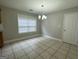 Simple dining room with tile floors and a chandelier at 235 Long Dr, Mcdonough, GA 30253