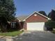 Brick house with a two-car garage and well-maintained lawn at 235 Long Dr, Mcdonough, GA 30253