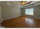 Spacious main bedroom with hardwood floors and large window at 235 Long Dr, Mcdonough, GA 30253
