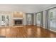 Living room featuring hardwood floors, fireplace, and French doors at 7377 Asbury Dr, Lithonia, GA 30058