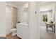 Clean bathroom with a shower/tub combo, white vanity, and neutral decor at 1944 Westwind Street, Lawrenceville, GA 30043