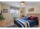 Cozy bedroom features natural light from the window, ceiling fan, and inviting blue bedding at 3700 Mays Sw Xing, Atlanta, GA 30331