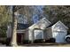 Charming single Gathering home with a large tree in the front yard and a red front door at 3700 Mays Sw Xing, Atlanta, GA 30331
