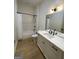 Bathroom with white vanity, bathtub, and hardwood floor at 165 Kelmscott Ln., Fayetteville, GA 30214