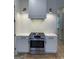 Stylish kitchen with gas range, marble countertops, and white cabinets at 165 Kelmscott Ln., Fayetteville, GA 30214