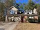 Two-story house with attached two-car garage and landscaping at 10420 Summer Creek Dr, Alpharetta, GA 30022