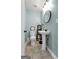 Small bathroom with pedestal sink, decorative shelving and light blue walls at 405 Miller Rd, Covington, GA 30014