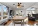 Bright dining room with large windows, hardwood floors, and a wooden dining table at 405 Miller Rd, Covington, GA 30014