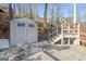 Grey storage shed near wooden steps leading to lake access at 405 Miller Rd, Covington, GA 30014