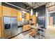 Modern kitchen with stainless steel appliances, light wood cabinets, and industrial-style lighting at 1661 La France St # 102, Atlanta, GA 30307