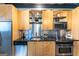 Contemporary kitchen features stainless steel appliances, light wood cabinets, and sleek black countertops at 1661 La France St # 102, Atlanta, GA 30307