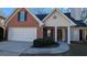 Brick and beige siding house with a two-car garage at 2673 Northforke Ct, Tucker, GA 30084