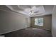 Large bedroom with carpet, ceiling fan, and window at 2673 Northforke Ct, Tucker, GA 30084