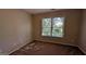 Bright bedroom with carpet flooring and a large window at 2673 Northforke Ct, Tucker, GA 30084