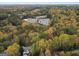 Aerial view of property and surrounding landscape showing wooded area and parking lot at 1153 Dawn View Nw Ln, Atlanta, GA 30327