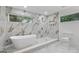 Spa-like bathroom with soaking tub and marble tile at 1153 Dawn View Nw Ln, Atlanta, GA 30327