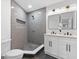 Modern bathroom with gray tile, double vanity, and walk-in shower at 1153 Dawn View Nw Ln, Atlanta, GA 30327