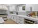 Modern kitchen with white cabinets, marble counters, and gold accents at 1153 Dawn View Nw Ln, Atlanta, GA 30327