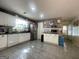 Kitchen with white cabinets, tile floor, and stainless steel appliances at 200 Kensington Trce, Stockbridge, GA 30281