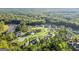 Aerial view of a neighborhood near a lake, showcasing various houses at 253 Gordon Oaks Way, Moreland, GA 30259