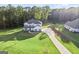 Two story house with white siding, large yard, and long driveway at 253 Gordon Oaks Way, Moreland, GA 30259