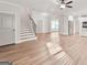 Open living room with hardwood floors and stairway at 253 Gordon Oaks Way, Moreland, GA 30259