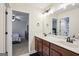 Bathroom with double vanity, white marble countertops, dark cabinets, and modern fixtures at 429 Burgundy Se Ter, Atlanta, GA 30354