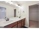 Bathroom showcasing a double vanity, white countertops and entry to closet at 429 Burgundy Se Ter, Atlanta, GA 30354