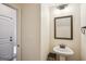 Simple powder room with pedestal sink and framed mirror at 429 Burgundy Se Ter, Atlanta, GA 30354