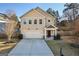 Tan two-story house, two-car garage, and a landscaped yard at 429 Burgundy Se Ter, Atlanta, GA 30354