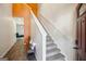 Bright foyer featuring hardwood floors, a staircase with carpet runner and an accent wall at 429 Burgundy Se Ter, Atlanta, GA 30354