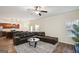 Spacious living room with dark leather sofa, ceiling fan, and views of the kitchen at 429 Burgundy Se Ter, Atlanta, GA 30354