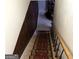 Basement stairs with wood railing and patterned carpet runner at 504 Plantation Creek Dr, Loganville, GA 30052