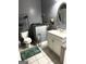 Bathroom with white vanity, oval mirror and tile floor at 504 Plantation Creek Dr, Loganville, GA 30052