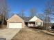 Brick ranch house with attached garage and landscaped yard at 504 Plantation Creek Dr, Loganville, GA 30052